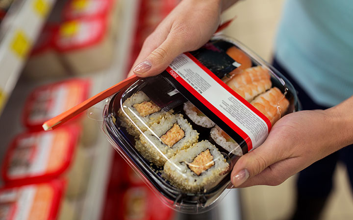 woman holding sushi box