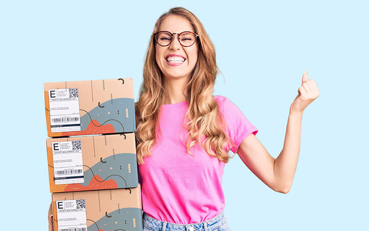 Woman holding stacked shipping boxes